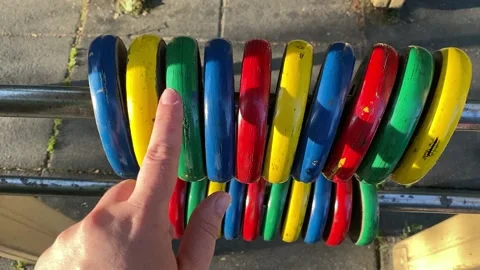 Hand counts colored rings on the playground. Stock Footage 194718236