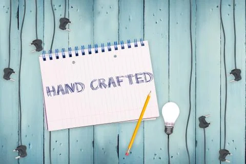 Hand crafted against notepad and plug on wooden background Stock Illustration