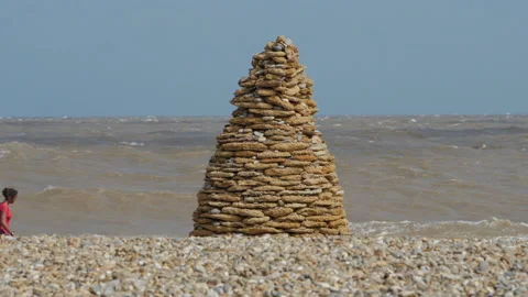 Hand crafted Cairn visually impresive Thorpeness landmark Stock Footage 196741429