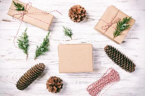 Hand crafted gift box on rustic white wooden background with Christmas decora 스톡 사진