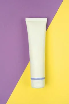 Hand cream, moisturiser, toothpaste, lotion jar plastic tube on lilac Stock Photos