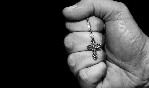 Hand with a cross Stock Photos