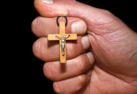 Hand with a cross Stock Photos