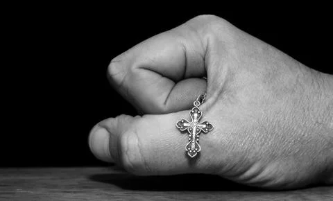 Hand with a cross Stock Photos