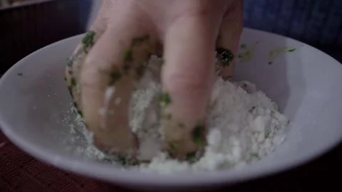 Hand crumbling fresh cheese on white plate Stock Footage 318323974