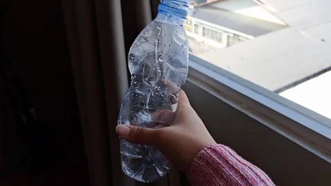 Hand Crumpling Plastic Water Bottle Stock Footage 331417474