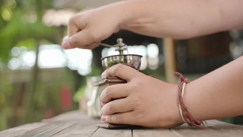 Hand crushing beans with coffee grinder Stock Footage 94210019