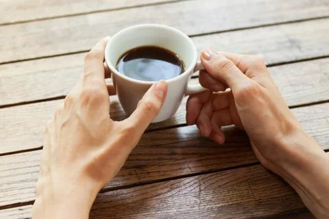 Hand with cup of coffee Stock Photos