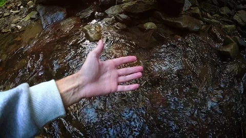 Hand Cups Water from Montain Stream in Slow Motion Stockbeeldmateriaal 97200322