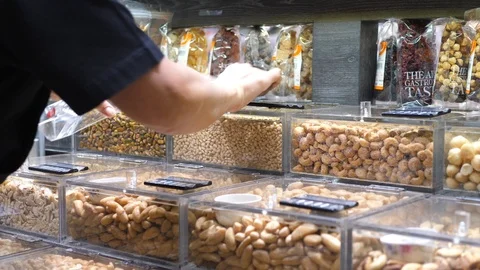 Hand Of Customer Buying Pine Nuts In Supermarket Stock Footage 106505779