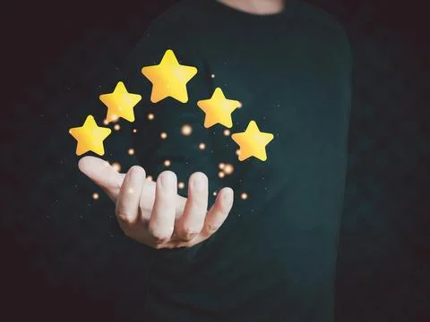 Hand of customer or client holding the stars to complete five stars with co.. Stock Photos