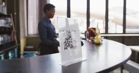 Hand of customer using smartphone to read qr code on the bar at a cafe Video stock 154822634