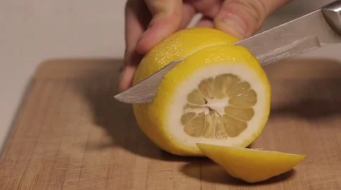 Hand cut with a knife lemon Stock Footage 61773789