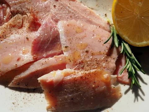 Hand-cut roasted ham with pepper, olive oil and herbs and spices 写真素材