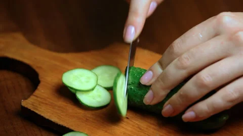 Hand Cuts Cucumber Rings CloseUp Video stock 30140082