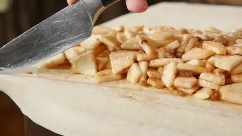 Hand cuts dough for baking knife, dough lying on table Stock Footage