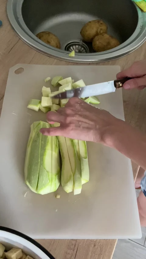 Hand Cuts Raw Zucchini With A Knife Video stock 246302358