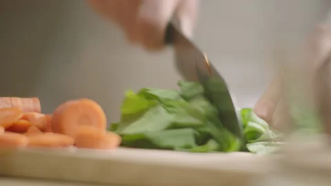 Hand cuts sorrel on the table Stock Footage 200937906