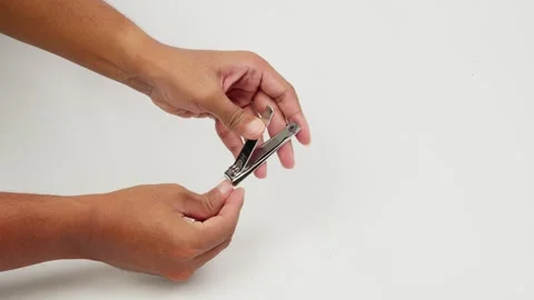 Hand Cutting Fingernails Using a Nail Clipper Stock Footage 327852636