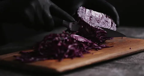 Hand cutting fresh red cabbage on Cutting Board Stock Footage 148245291