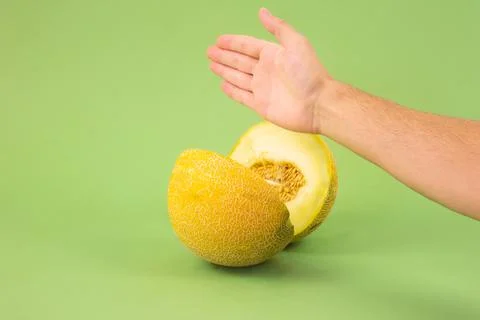 Hand cutting a melon. Stock Photos