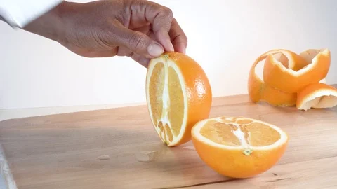 Hand cutting orange with knife Stock Footage 124444748