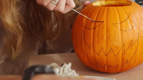 Hand Cutting Pumpkin Face Design For Halloween Stock Footage 312224743