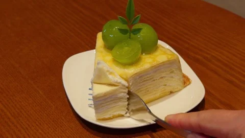 Hand Cutting Slice of Crepe Cake with Fork on White Plate Close-Up Dessert 库存影片 346948131