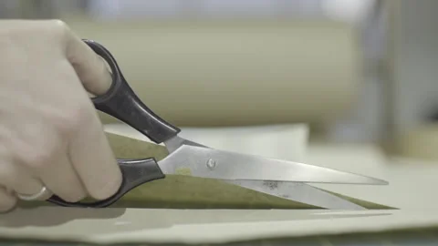 Hand cutting wrapping paper with scissors Stock Footage 160522102