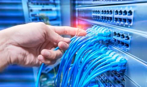 Hand with damaged stranded network cable. Problem with communication Stock Photos
