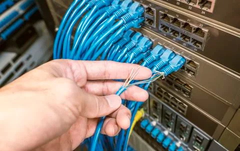 Hand with damaged stranded network cable. Problem with communication Stock Photos