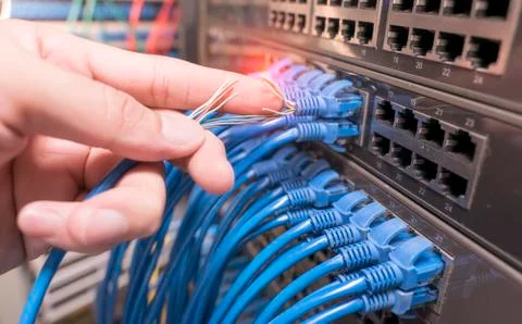 Hand with damaged stranded network cable. Problem with communication 写真素材