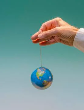 Hand with dangling globe 6 Stock Photos