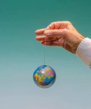 Hand with dangling globe 7 Stock Photos