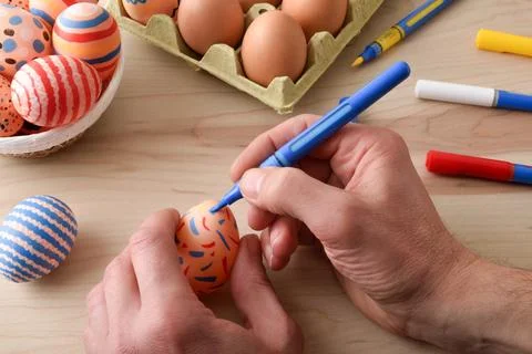 Hand Decorating Easter Egg with Colorful Marker Stock Photos