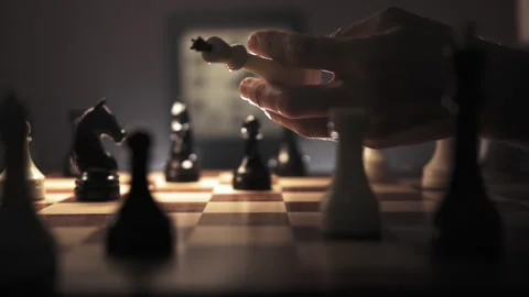 Hand deftly juggles a queen then places a piece in the center of the chessboard Stock Footage 312812294