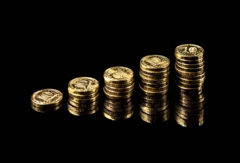 Hand deliver a stack of coins graph profit growth on black background Stock Photos