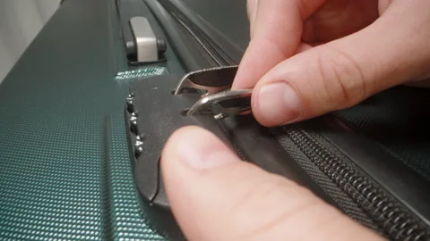 A Hand demonstrates how to use the combination lock, adjusting the code to Stock Footage 282297147