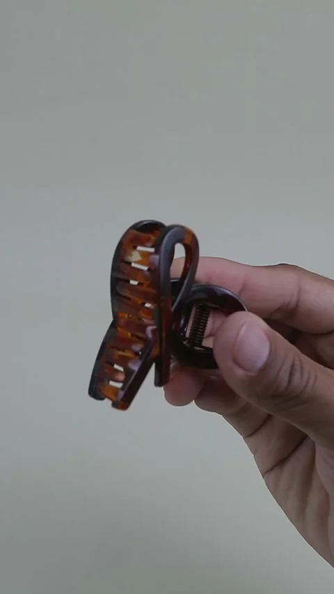 Hand Demonstrating Opening and Closing Plastic Hair Claw Clip Stock Footage 333240687