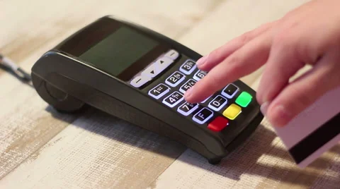 Hand dialing pin code and swipe credit card in pos terminal Stock Footage 65392414