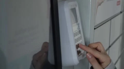 The hand dials the code on the terminal. The concept of picking up your order Stock Footage 297461190