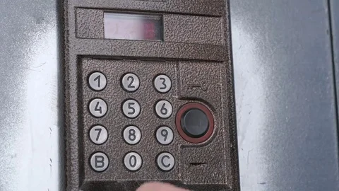 Hand dials number of apartment on intercom system Stock Footage 69213396