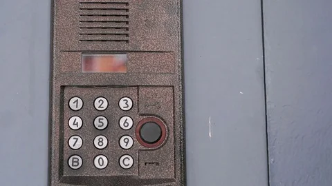 Hand dials number of apartment on intercom system Stock Footage 70217330