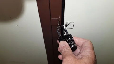 Hand dials a secret code on padlock Stock Footage 119578253