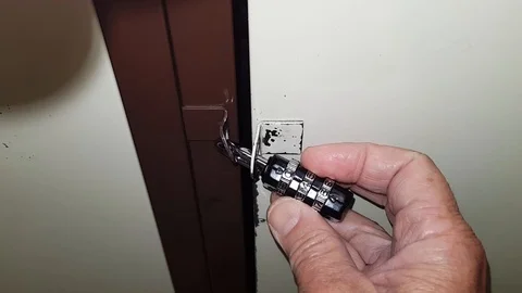 Hand dials a secret code on padlock Stock Footage 119579107