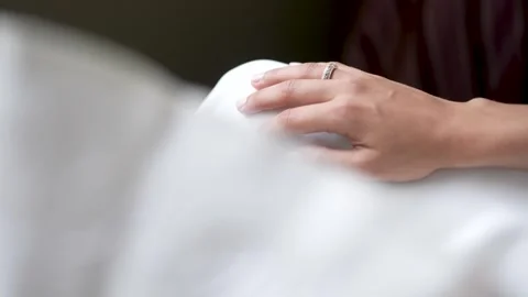 Hand With Diamond Ring Resting On A White Wedding Dress Stock Footage 343806413