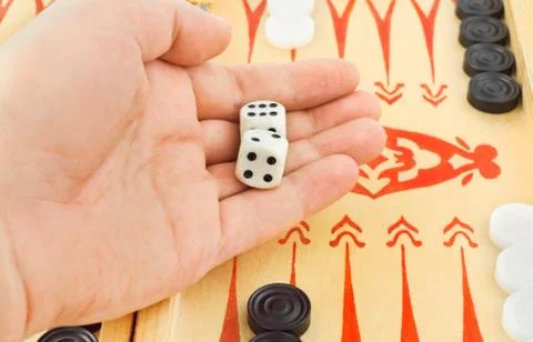 Hand with dices and backgammon Stock Photos
