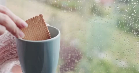 Hand Dipping Biscuit in cup of Hot Coffee, Rainy Window. 4K SLOW MOTION 120 fps 스톡 동영상 67230001