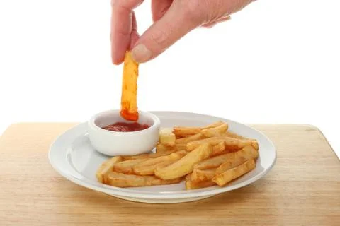 Hand dipping a chip Stock Photos