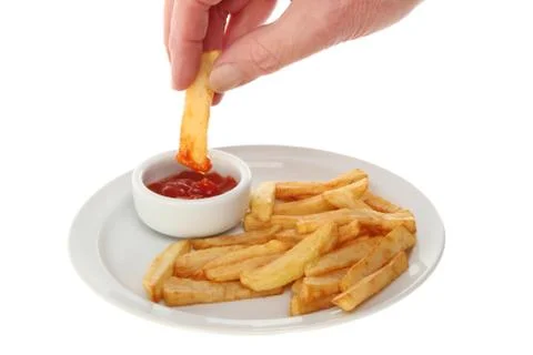 Hand dipping chip Stock Photos
